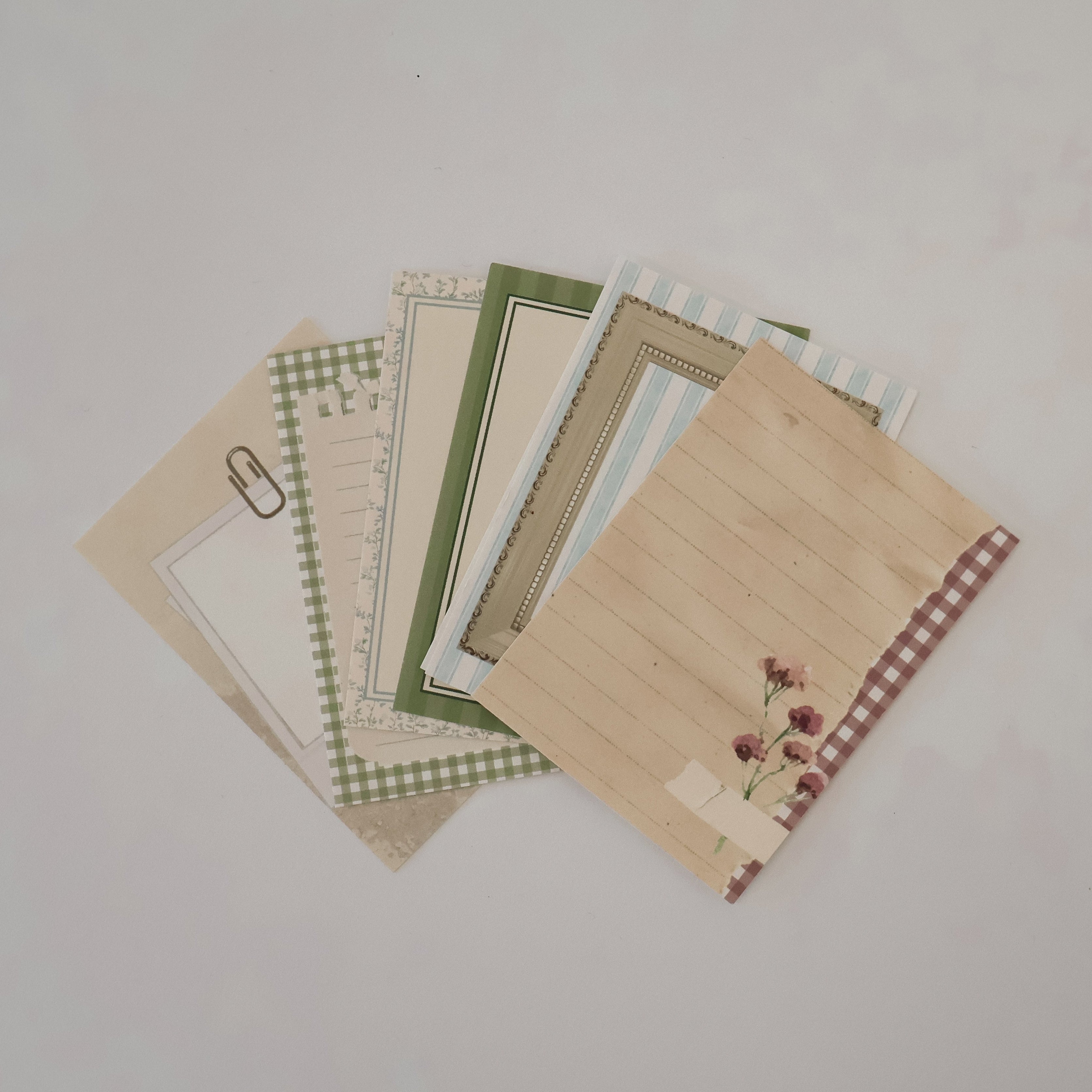 Set of patterned paper sheets on a plain background