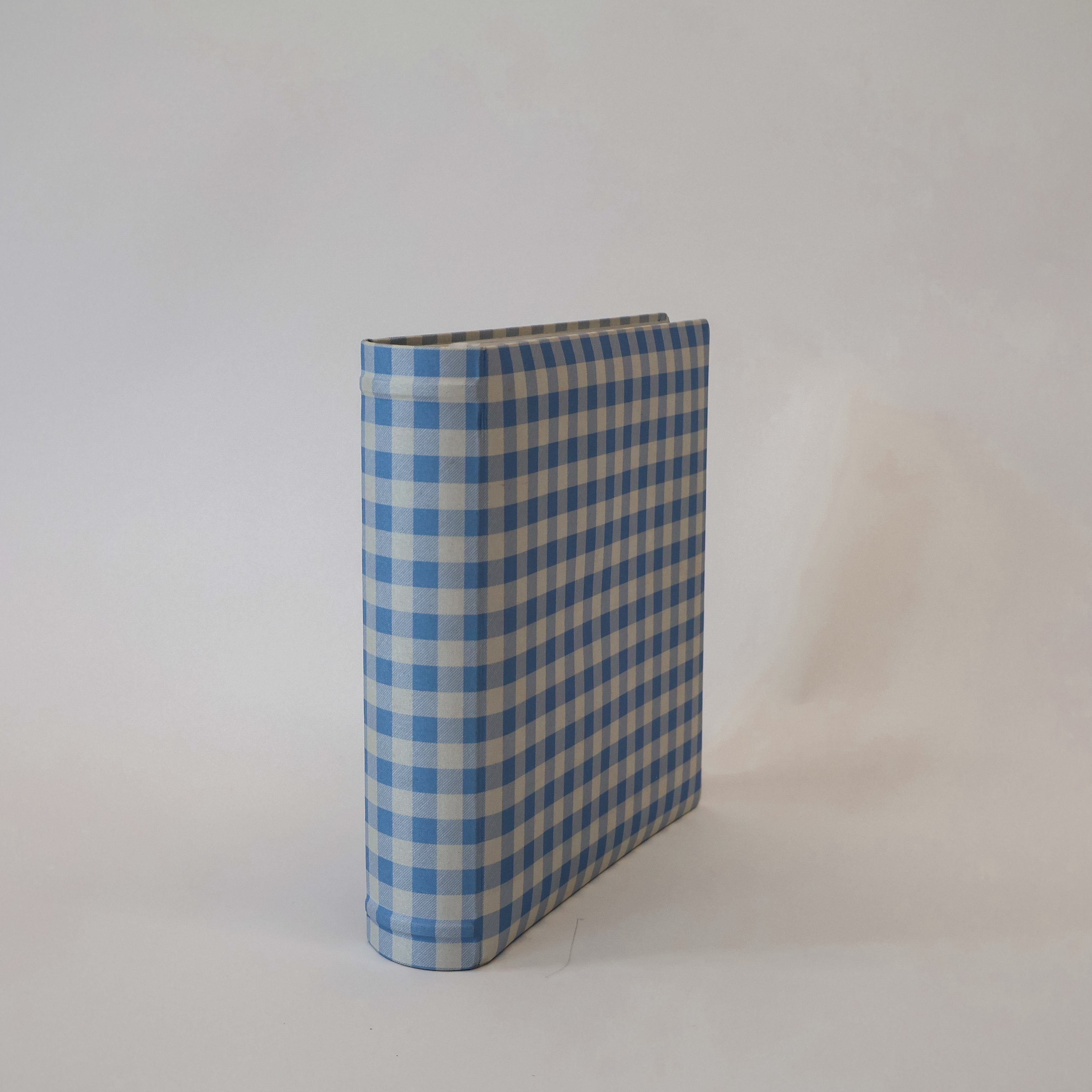 Blue and beige checkered scrapbook album on a white background