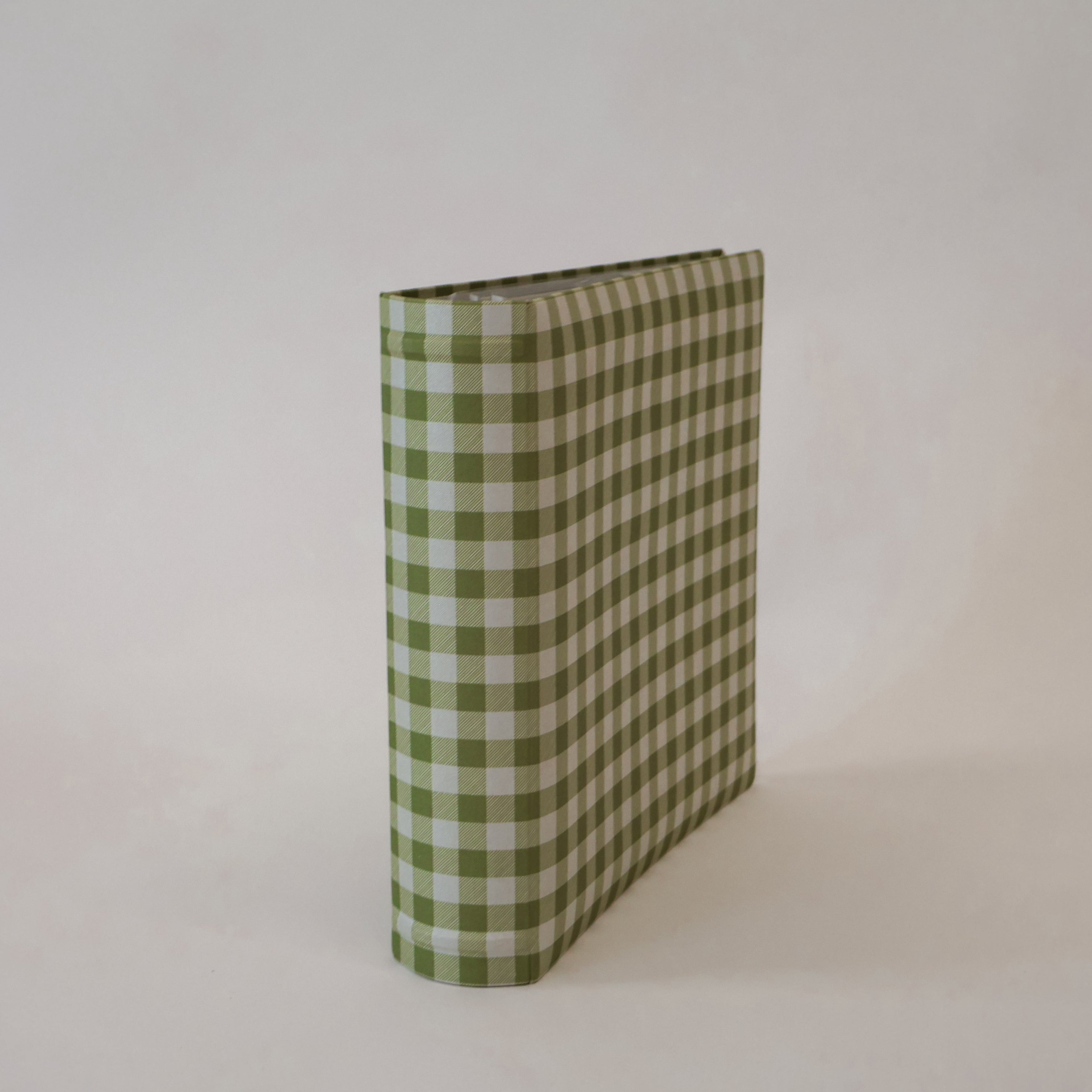 Green and white checkered scrapbook album on a light gray background