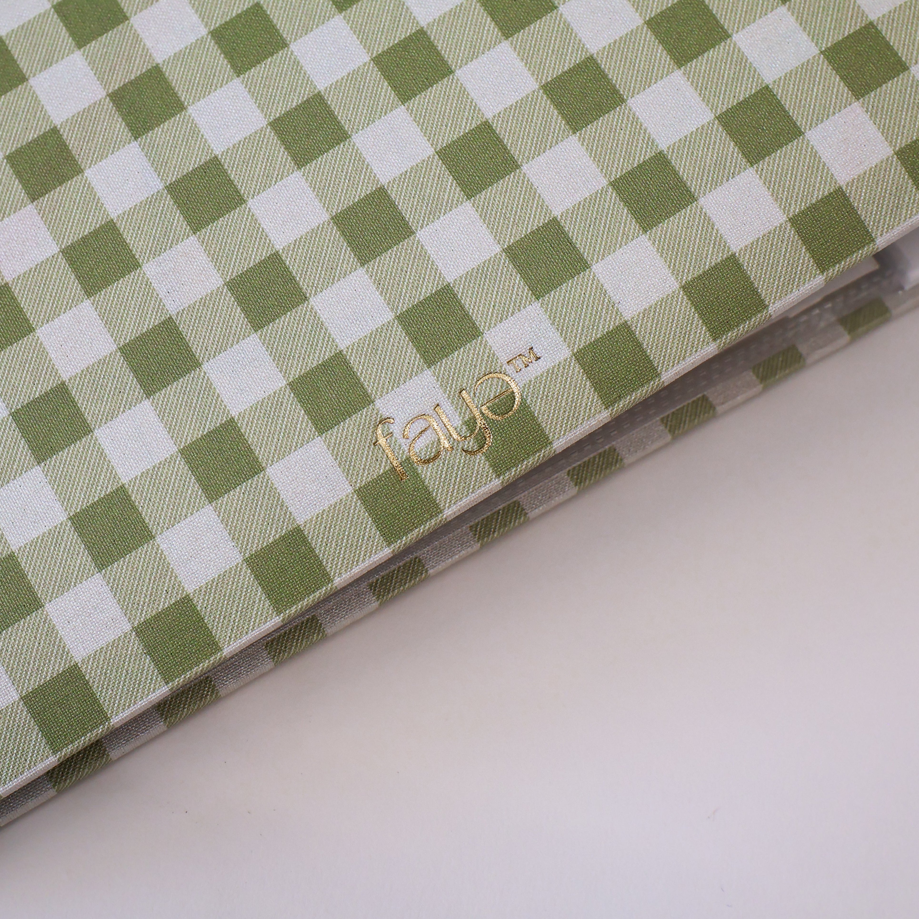 Green and white checkered photo album with 'faye' branding on a white background
