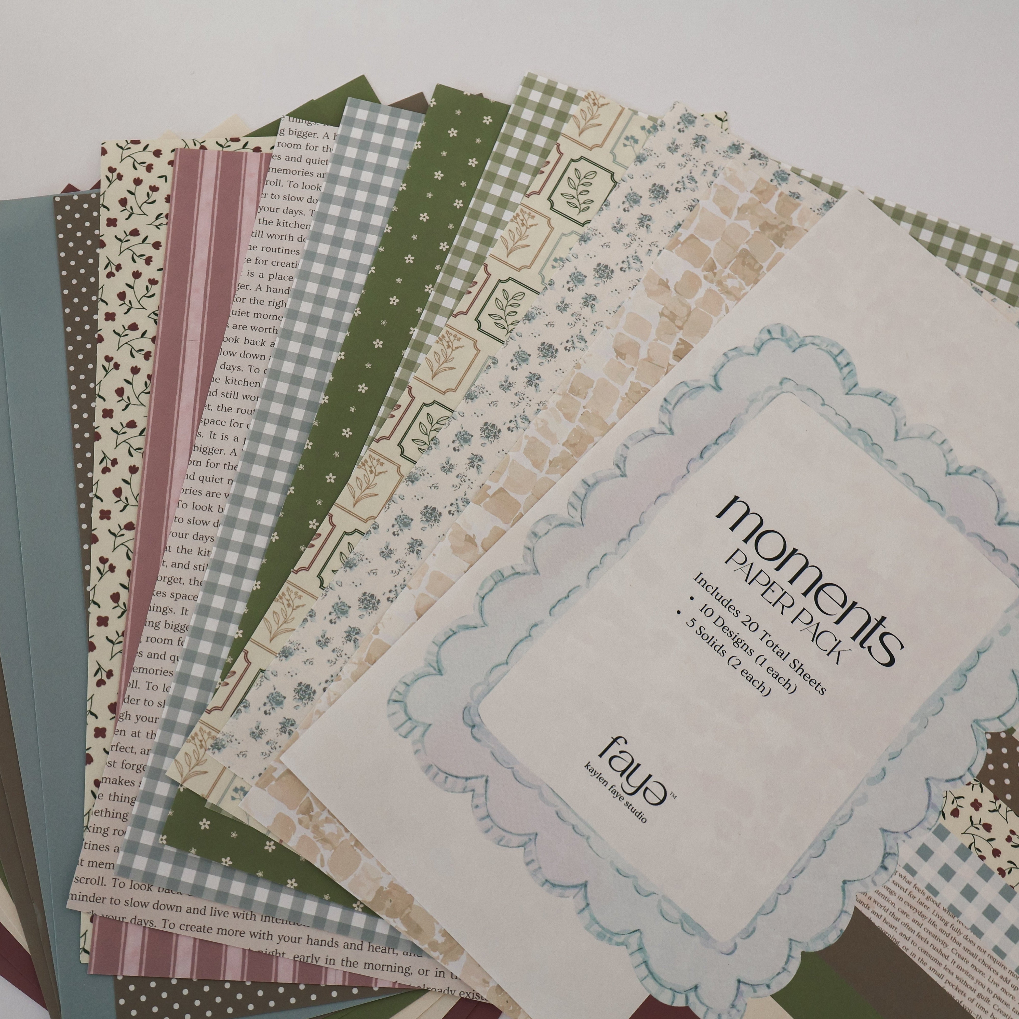 Collection of patterned paper sheets with a brand label on a white background