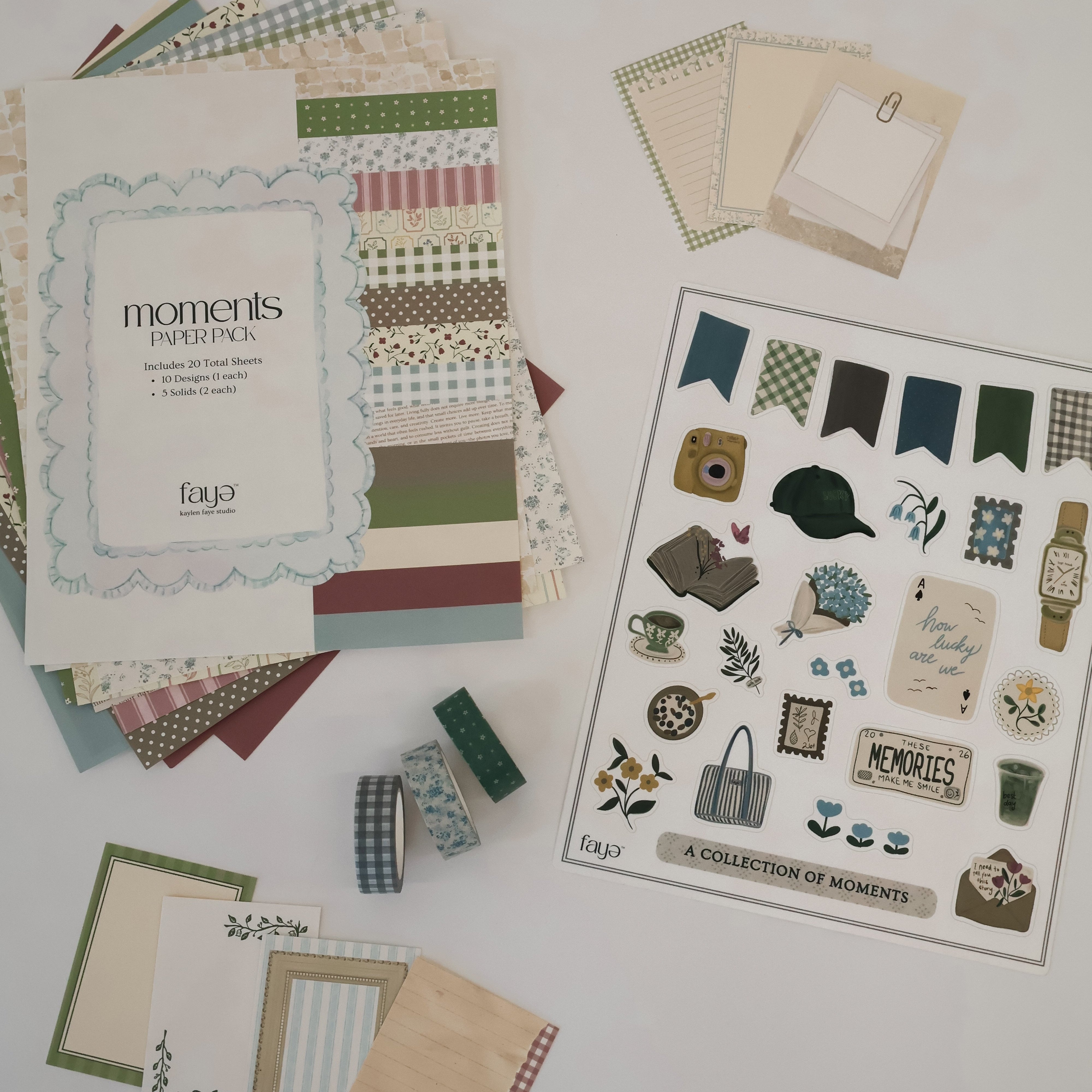 Collection of scrapbooking paper and stickers on a white surface 