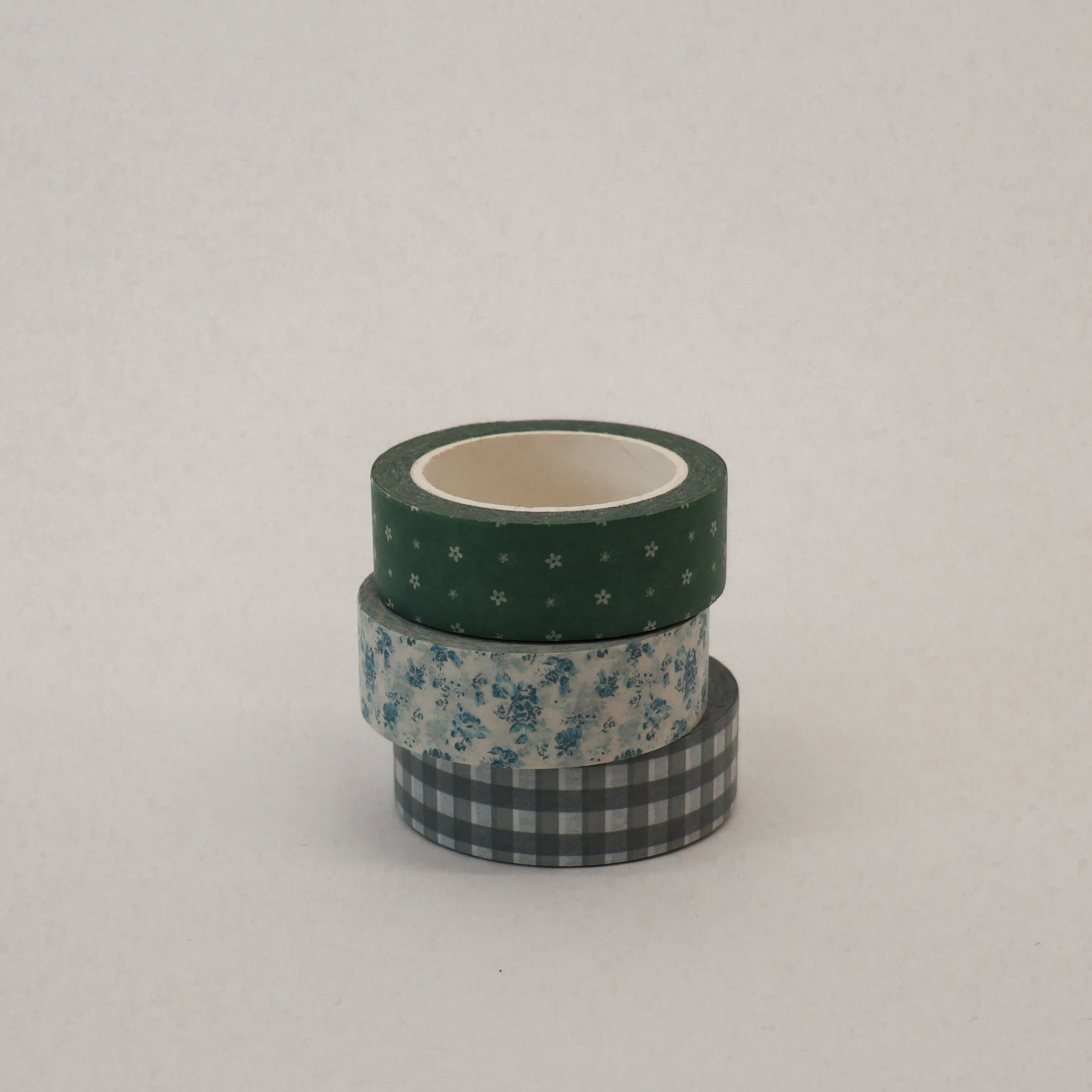 Three rolls of washi tape with different patterns on a light gray background