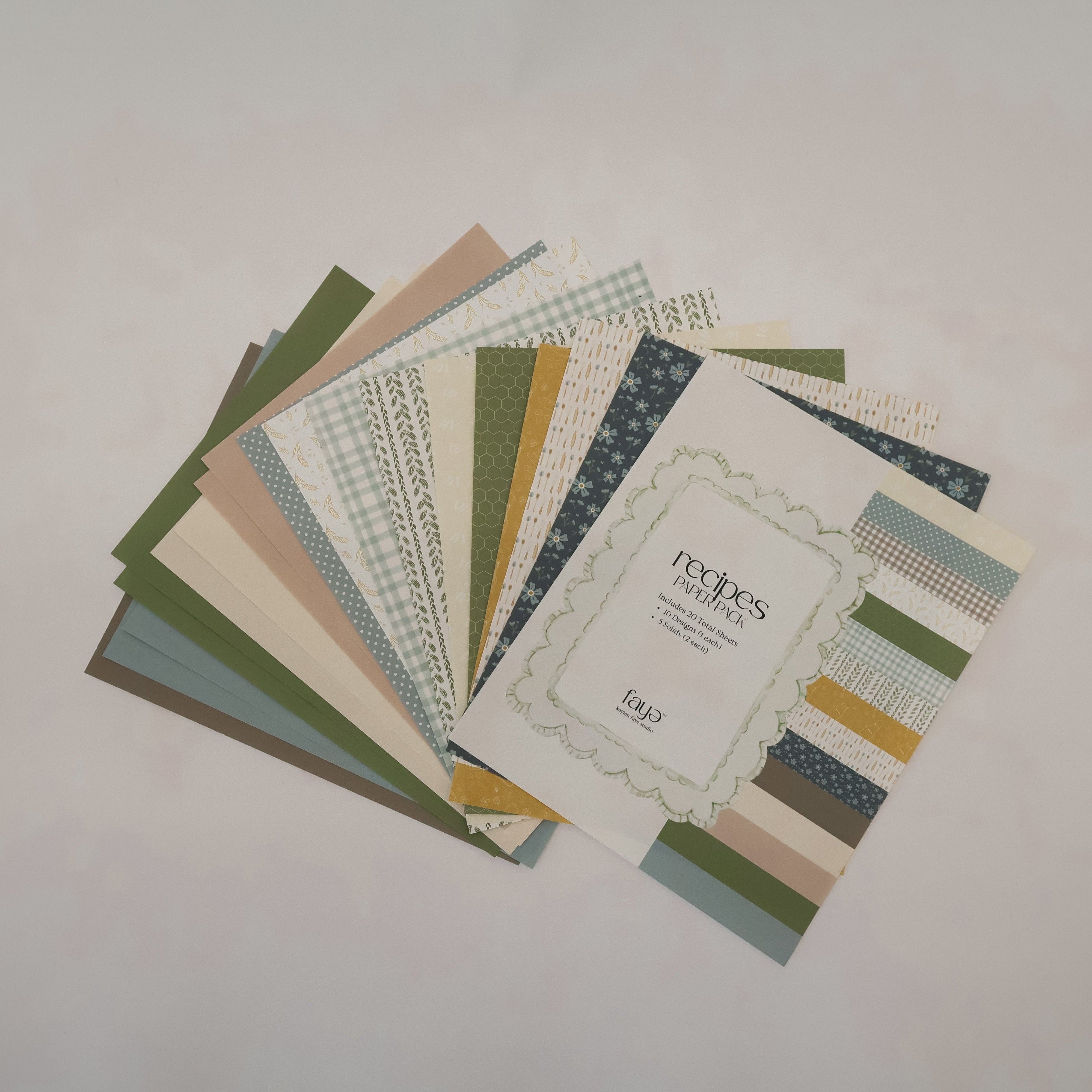 Collection of patterned paper sheets on a light gray background