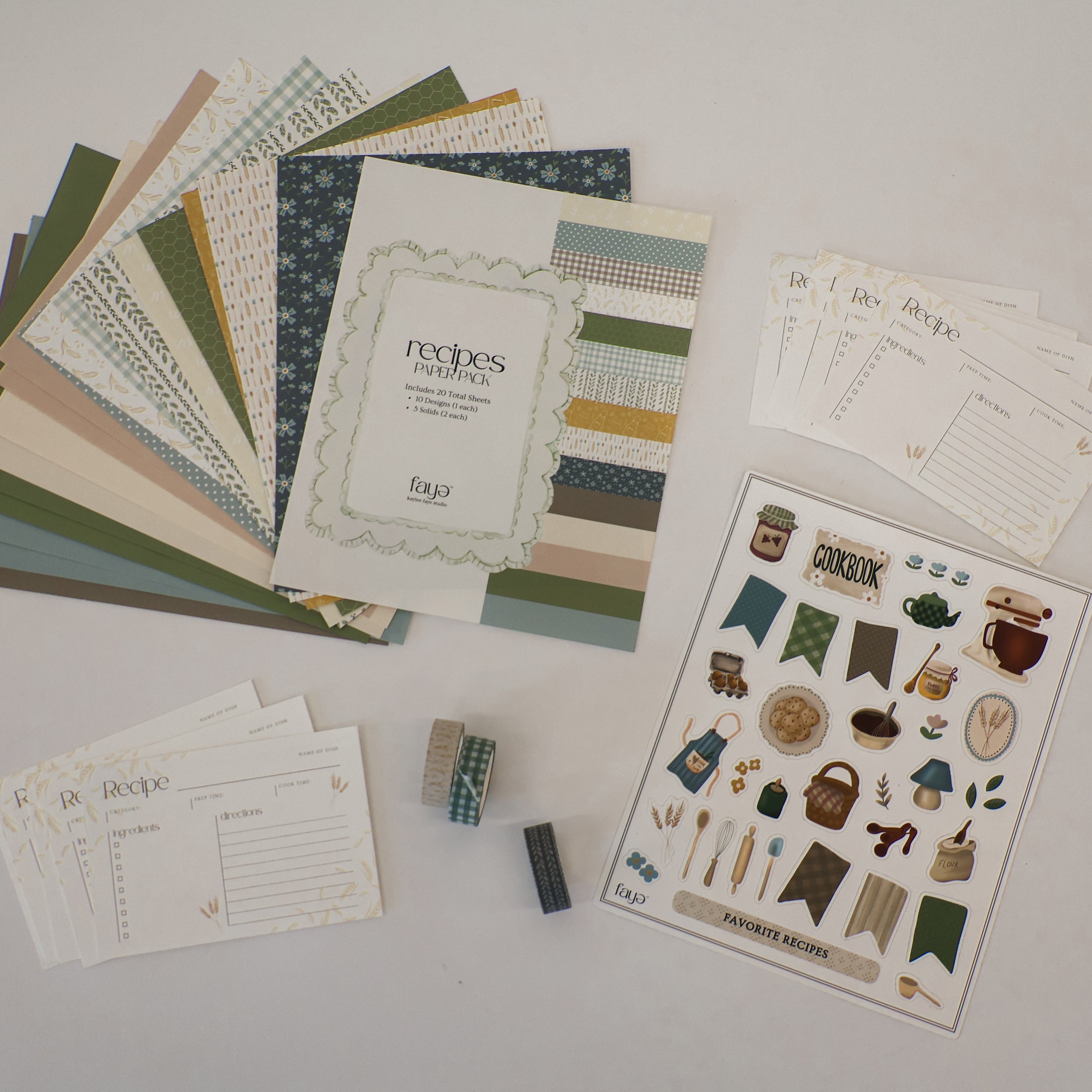 Collection of stationery items including paper, stickers, and recipe cards on a light surface.