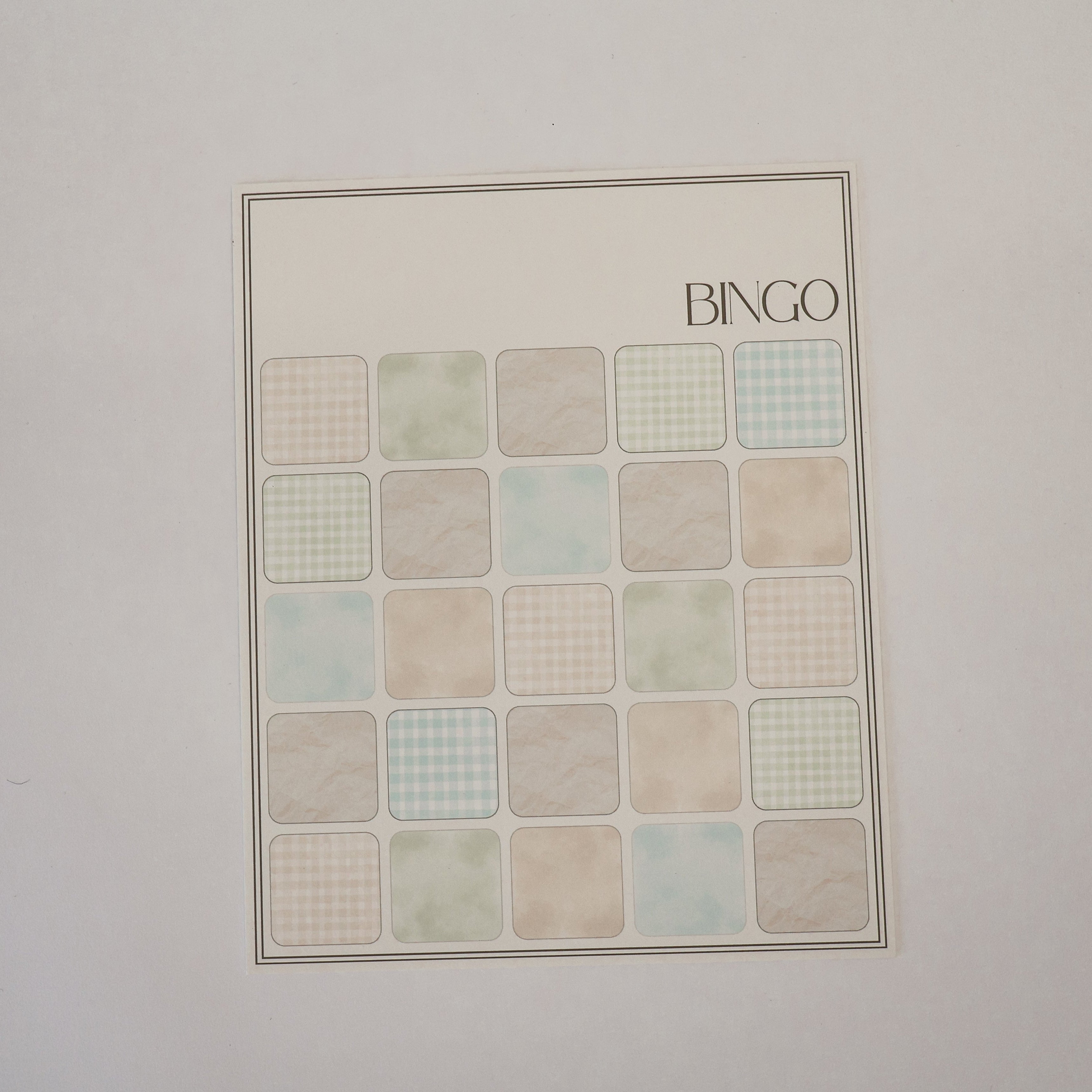 Bingo card with colored squares on a plain background